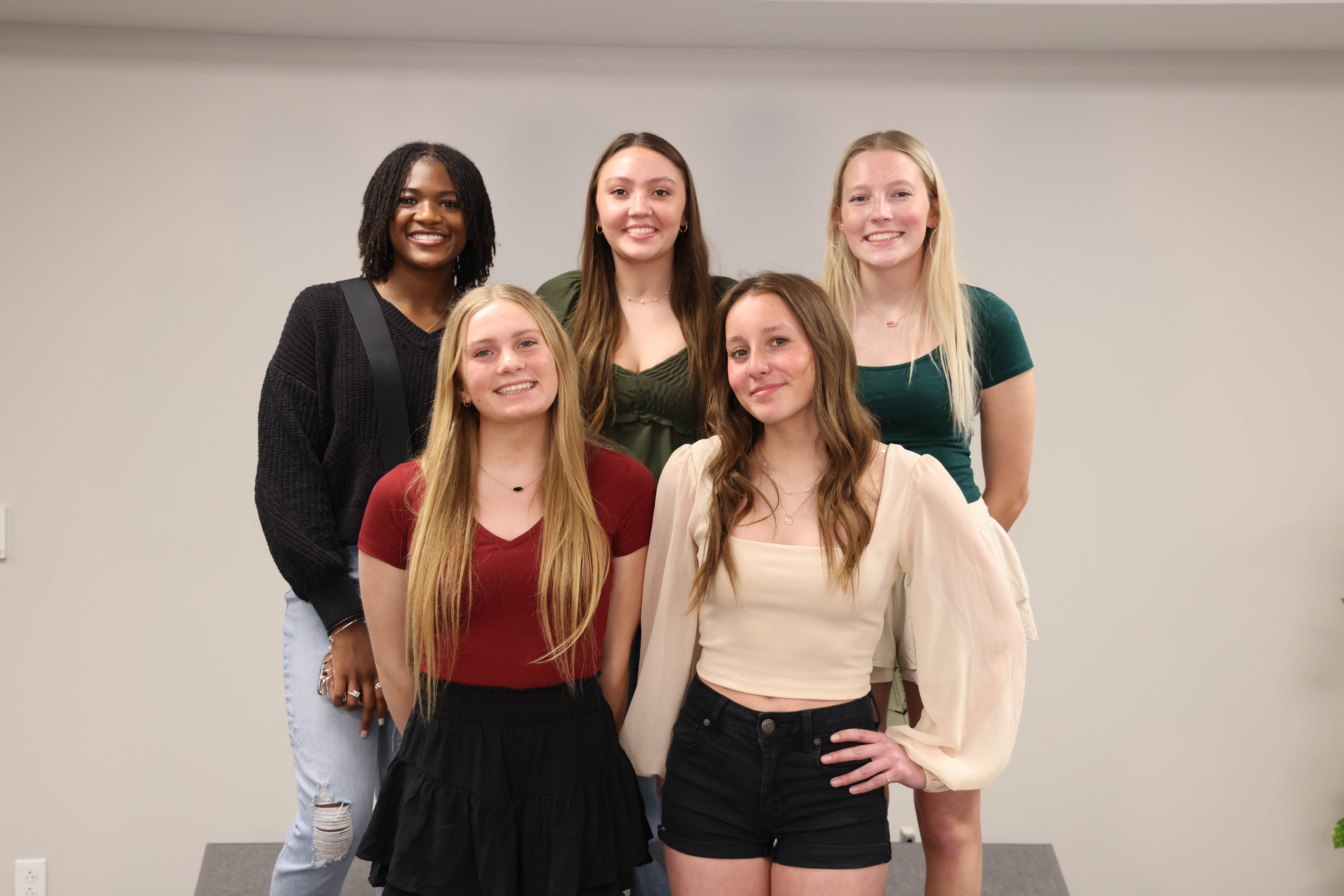 Five members of the girls swim and dive team pose for a picture