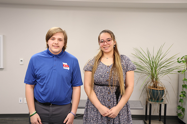 Two students are pictured at a recognition event.
